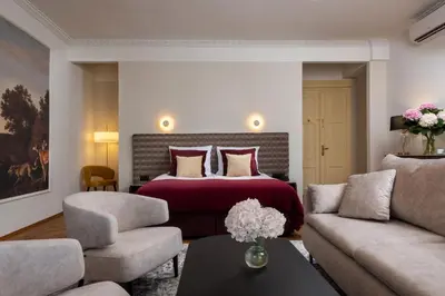a hotel room with a bed and a couch at Hotel Palladian in Kraków