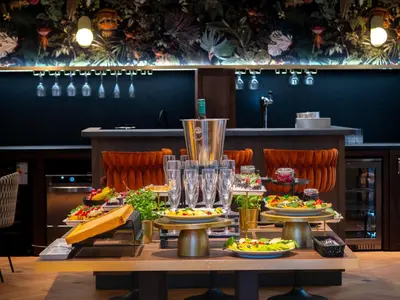 a table with plates of food on it at Hotel Palladian in Kraków