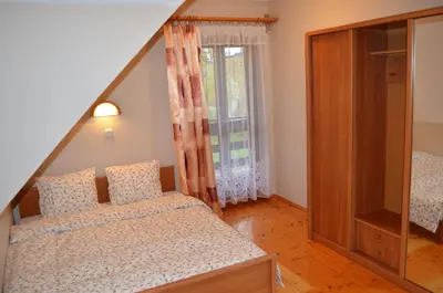 a bedroom with two beds and a window at Dom na Mosornym Groniu in Zawoja