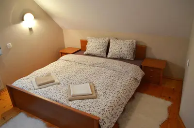 a bedroom with a bed with two pillows on it at Dom na Mosornym Groniu in Zawoja