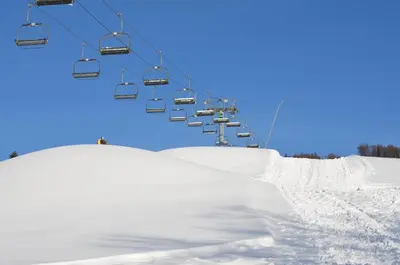 a ski lift with a pile of snow next to a ski slope at Dom na Mosornym Groniu in Zawoja