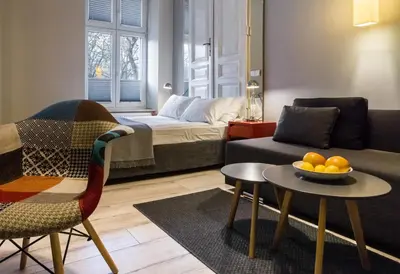 a living room with a couch and a table with a bowl of oranges at Yourplace M57 Apartments in Kraków