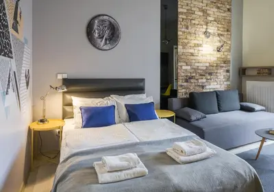 a bedroom with a large bed and a couch at Yourplace M57 Apartments in Kraków