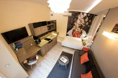 a small room with a bed and a desk at Yourplace M57 Apartments in Kraków
