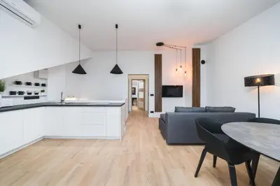 a kitchen and living room with a couch and a table at Flower Residence in Kraków