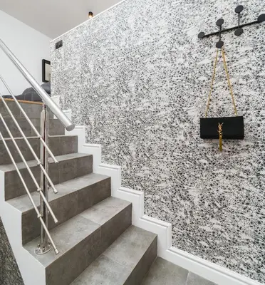 a staircase with a stone wall with a cross on it at Flower Residence in Kraków
