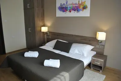 a bedroom with a bed with two towels on it at Hotel Zakliki in Kraków