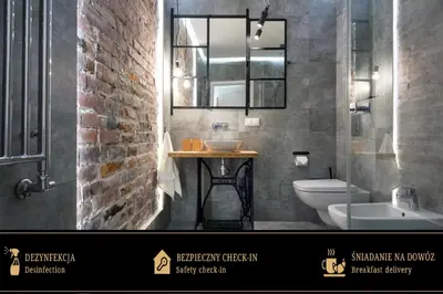 a bathroom with a sink and a toilet and a mirror at Zwierzyniecka Old Town Apartments by Otium in Kraków