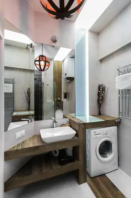 a bathroom with a washing machine and a sink at Zwierzyniecka Old Town Apartments by Otium in Kraków