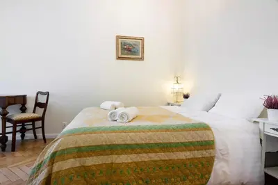 a bedroom with a bed with towels on it at Zwierzyniecka Old Town Apartments by Otium in Kraków