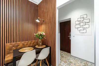 a dining room with a table and a couch at Horizon Apartments - Plac Nowy in Kraków