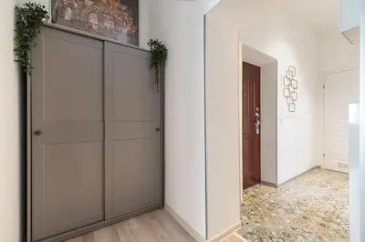 a room with white walls and a closet with plants on it at Horizon Apartments - Plac Nowy in Kraków