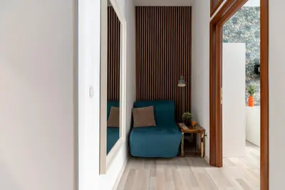 a room with a blue chair and a table at Horizon Apartments - Plac Nowy in Kraków