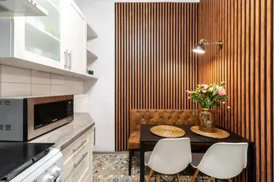 a kitchen with a table with a vase of flowers at Horizon Apartments - Plac Nowy in Kraków