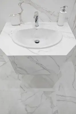 a white sink in a white marble bathroom at Elegant City Center Apartment 7A in Kraków