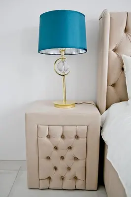 a lamp on a night stand next to a bed at Elegant City Center Apartment 7A in Kraków