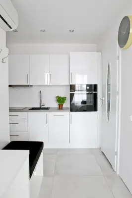 a white kitchen with a sink and a refrigerator at Elegant City Center Apartment 7A in Kraków