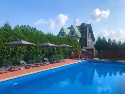 a group of people standing around a swimming pool at Ośrodek Sportowo-Rekreacyjny Słoneczny in Mszana Dolna