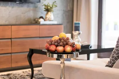 a tray of fruit on a table in a living room at Kings City - Skawińska Apartment in Kraków