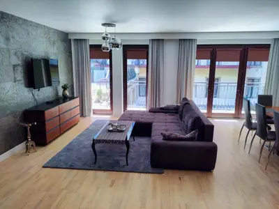 a living room with a couch and a table at Kings City - Skawińska Apartment in Kraków