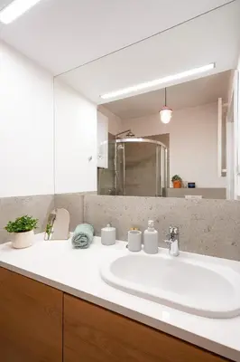 a bathroom with a white sink and a mirror at Avium Old Town Apartments in Kraków