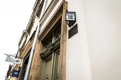 a building with a clock on the side of it at Avium Old Town Apartments in Kraków