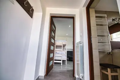 a hallway with a door leading into a room at Apartamenty i Domki u Basi in Zator