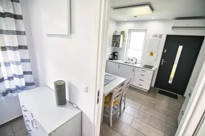 a small kitchen with a table and a sink at Apartamenty i Domki u Basi in Zator