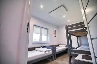 a room with two bunk beds and a window at Apartamenty i Domki u Basi in Zator