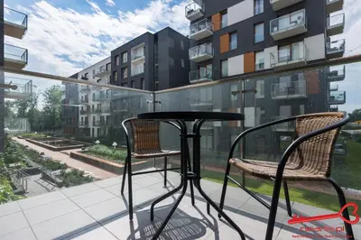 a table and two chairs on a balcony with a view at Apartments Nearto Old Town Rakowicka in Kraków