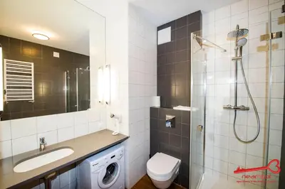 a bathroom with a toilet sink and a shower at Apartments Nearto Old Town Rakowicka in Kraków