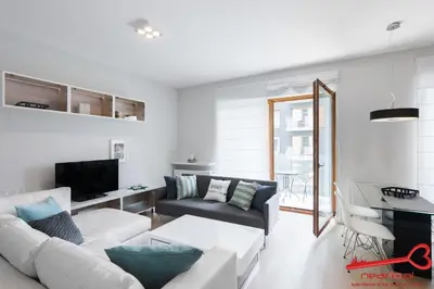 a living room with a couch and a tv at Apartments Nearto Old Town Rakowicka in Kraków