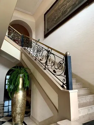 a staircase with a vase next to a stair case at Rezydencja Pod Zegarem in Trzebinia