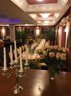 a long table with white candles and flowers on it at Rezydencja Pod Zegarem in Trzebinia