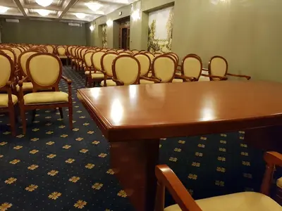 a row of chairs in a room with tables and chairs at Rezydencja Pod Zegarem in Trzebinia