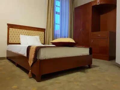 a bedroom with a bed with a dresser and a window at Rezydencja Pod Zegarem in Trzebinia