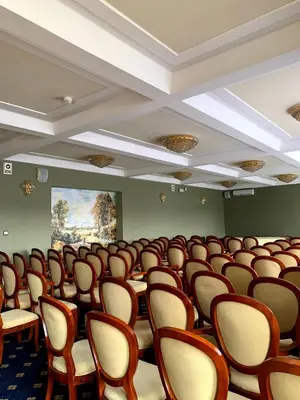 an empty room with rows of chairs and tables at Rezydencja Pod Zegarem in Trzebinia