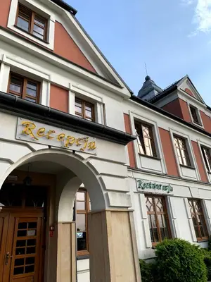 a building with an arch in front of it at Rezydencja Pod Zegarem in Trzebinia