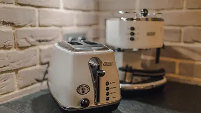 a toaster sitting on a counter next to a brick wall at Main Street Apartments in Kraków