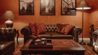 a living room with a leather couch and a coffee table at Main Street Apartments in Kraków