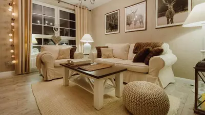 a living room with a couch and a table at Main Street Apartments in Kraków