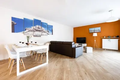 a living room with a white table and a couch at Apartments Kremer Cracow in Kraków