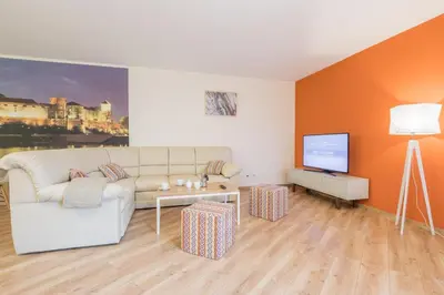 a living room with a couch and a tv at Apartments Kremer Cracow in Kraków