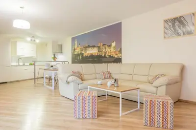 a living room with a couch and a table at Apartments Kremer Cracow in Kraków
