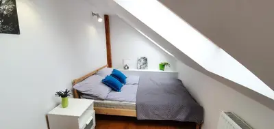 a room with a bed with blue pillows on it at Old Town, Apartment, Blich in Kraków