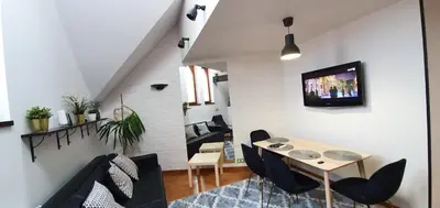 a living room with a table and chairs and a tv at Old Town, Apartment, Blich in Kraków