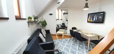 a living room with a black couch and a table at Old Town, Apartment, Blich in Kraków