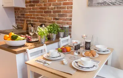 a dining room table with fruits and vegetables on it at Gertrudy Old Town Apartments in Kraków