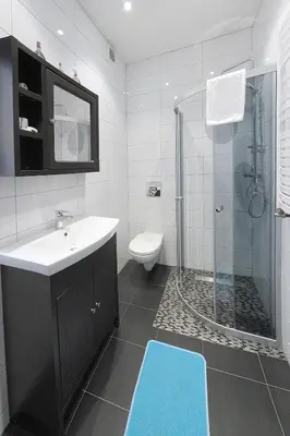 a bathroom with a toilet and a sink and a shower at 7th Room Guest House in Oświęcim