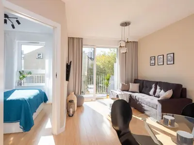 a living room with a couch and a table at Lofts Cracow Apartments - City Center in Kraków